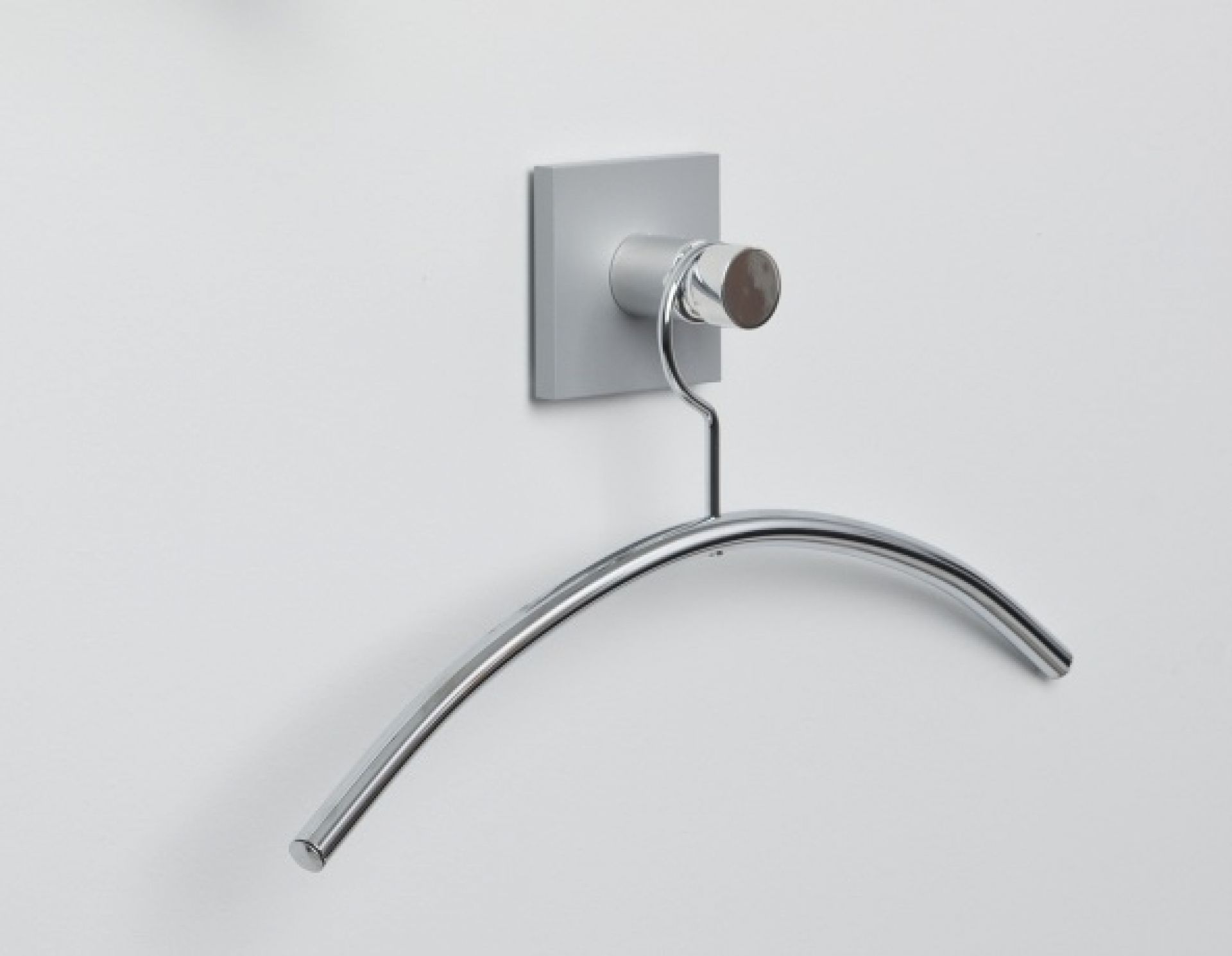 Hangon 1 Kleiderhaken aus poliertem Aluminium mit Kleiderbügel an einer weißen Wand.